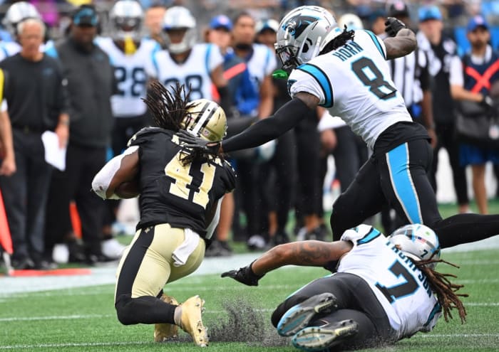 Sep 25, 2022; New Orleans Saints running back Alvin Kamara (41) is tackled by Carolina Panthers cornerback Jaycee Horn (8) and linebacker Shaq Thompson (7). Mandatory Credit: Bob Donnan-USA TODAY Sports
